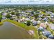 Neighborhood aerial view highlighting lakefront homes with neat landscaping, trees, and a community setting at 2681 Debany Rd, Kissimmee, FL 34744