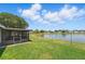 Beautiful backyard overlooking a lake and featuring a screened-in lanai at 2681 Debany Rd, Kissimmee, FL 34744