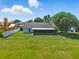 Large fenced-in backyard with a covered patio, perfect for outdoor entertaining at 2681 Debany Rd, Kissimmee, FL 34744