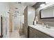 Bathroom featuring a glass shower door, ample cabinet space, and a neutral color palette at 2681 Debany Rd, Kissimmee, FL 34744