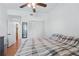Bedroom featuring a checkered blanket, ceiling fan, and shuttered closet doors at 2681 Debany Rd, Kissimmee, FL 34744