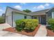 Charming home exterior featuring manicured landscaping and a welcoming entrance at 2681 Debany Rd, Kissimmee, FL 34744