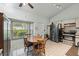 Cozy kitchen with white cabinets, stainless steel appliances, and a light-filled breakfast nook with a wooden dining set at 2681 Debany Rd, Kissimmee, FL 34744