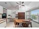 Bright eat-in kitchen featuring white cabinets, stainless steel appliances, and a breakfast nook with seating at 2681 Debany Rd, Kissimmee, FL 34744