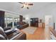 Cozy living room with a ceiling fan, hardwood floors, and sliding doors leading to the outdoors at 2681 Debany Rd, Kissimmee, FL 34744