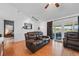 Bright living room featuring wood floors, a ceiling fan, and sliding glass doors to the patio at 2681 Debany Rd, Kissimmee, FL 34744