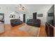 Bright living room with wood floors, vaulted ceiling, ceiling fan, and comfortable seating at 2681 Debany Rd, Kissimmee, FL 34744