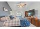 Comfortable main bedroom featuring a ceiling fan, large TV, and a scenic water view at 2681 Debany Rd, Kissimmee, FL 34744