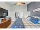 Comfortable main bedroom featuring a ceiling fan, large TV, ensuite access, and neutral walls at 2681 Debany Rd, Kissimmee, FL 34744