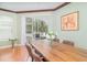 Dining room featuring wood floors, natural light, and access to outdoor balcony at 2717 Maitland Crossing # 207, Orlando, FL 32810