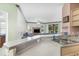Kitchen with stainless steel appliances and breakfast bar, flows to the living room at 2717 Maitland Crossing # 207, Orlando, FL 32810
