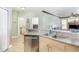 Bright kitchen featuring stainless steel appliances, tile flooring, and views to the living room at 2717 Maitland Crossing # 207, Orlando, FL 32810