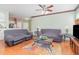 Comfortable living room showcases wood floors, a ceiling fan and ample lighting at 2717 Maitland Crossing # 207, Orlando, FL 32810