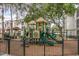 Fenced community playground with slides, climbing structures, and a soft ground surface at 2717 Maitland Crossing # 207, Orlando, FL 32810