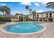 Community swimming pool with lounge chairs and well-maintained landscaping in the background at 2717 Maitland Crossing # 207, Orlando, FL 32810