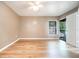 Bright bedroom with laminate flooring, a ceiling fan, and sliding glass door at 2924 S Semoran Blvd # D2, Orlando, FL 32822
