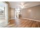 Spacious bedroom with wood-look floors, ceiling fan, and ensuite bathroom at 2924 S Semoran Blvd # D2, Orlando, FL 32822