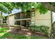Exterior view of building featuring screened balconies, lush landscaping, and a well-maintained lawn at 2924 S Semoran Blvd # D2, Orlando, FL 32822