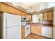 Functional kitchen with white appliances, light wood cabinetry, and tile countertops at 2924 S Semoran Blvd # D2, Orlando, FL 32822
