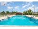 Community pool with tennis courts and clubhouse in the background on a sunny day at 2924 S Semoran Blvd # D2, Orlando, FL 32822