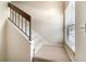 Carpeted staircase with wooden handrail and natural light from window at 2924 S Semoran Blvd # D2, Orlando, FL 32822