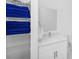 Bathroom with a white vanity, bright mirror, and organized towel closet at 296 Famagusta Dr, Davenport, FL 33896