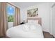 Bright bedroom featuring comfortable bedding and a sunny window with an outdoor landscape view at 296 Famagusta Dr, Davenport, FL 33896