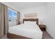 Bright bedroom with a cozy bed, swan towel art, and a sunny window with neighborhood views at 296 Famagusta Dr, Davenport, FL 33896