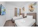 Bright bedroom featuring two twin beds, modern decor, and neutral tones providing a cozy ambiance at 296 Famagusta Dr, Davenport, FL 33896
