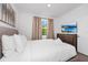 Bright bedroom with a large television and sunny window with outdoor landscape views at 296 Famagusta Dr, Davenport, FL 33896