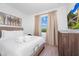 Light bedroom with large television and view of outdoor landscape from a sunny window with curtains at 296 Famagusta Dr, Davenport, FL 33896