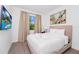 Bright bedroom with a comfy bed and a view of the outdoor landscape from a large window at 296 Famagusta Dr, Davenport, FL 33896
