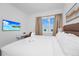 Comfortable bedroom with a sleek work desk area, television, and large window allowing plenty of natural light at 296 Famagusta Dr, Davenport, FL 33896