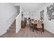 Elegant dining area featuring a modern table with seating for six, stylish lighting, and seamless access to the kitchen at 296 Famagusta Dr, Davenport, FL 33896