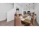 Bright dining space with a sleek table, modern decor, and a convenient transition to the open-concept kitchen area at 296 Famagusta Dr, Davenport, FL 33896