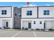 Modern townhome featuring contemporary design, stone accents, and ample parking for residents and guests at 296 Famagusta Dr, Davenport, FL 33896