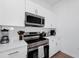Well-equipped kitchen with stainless steel appliances and white countertops at 296 Famagusta Dr, Davenport, FL 33896