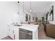 Open kitchen with quartz countertops and stainless steel appliances overlooks the dining and living areas at 296 Famagusta Dr, Davenport, FL 33896