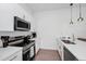Clean kitchen featuring stainless steel appliances, white cabinets, and bright countertops at 296 Famagusta Dr, Davenport, FL 33896