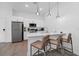 Modern kitchen features stainless steel appliances, white cabinetry, and stylish pendant lighting at 296 Famagusta Dr, Davenport, FL 33896