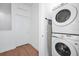 Efficient laundry area with stacked washer and dryer, ironing board, and convenient layout at 296 Famagusta Dr, Davenport, FL 33896