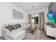 Cozy living room with a plush sectional sofa, contemporary decor, and sliding glass doors to outdoor patio at 296 Famagusta Dr, Davenport, FL 33896