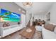 Chic living area with open layout, featuring sleek decor, a staircase, and seamless transition to dining and kitchen at 296 Famagusta Dr, Davenport, FL 33896