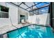 Beautiful pool area with lounge chairs, privacy walls, and screen enclosure to maximize outdoor enjoyment at 296 Famagusta Dr, Davenport, FL 33896