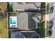 Aerial view of a modern home, showcasing a private pool, stylish patio furniture, and well-maintained landscaping at 3310 Stonewyck St, Orlando, FL 32824