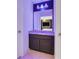 Small bathroom with dark vanity, granite countertop, mirror and modern lighting at 3310 Stonewyck St, Orlando, FL 32824