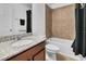 Well-lit bathroom with granite countertop, sink, tub and shower with ceramic tile at 3310 Stonewyck St, Orlando, FL 32824