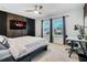 Comfortable bedroom with a desk, TV, and view to neighborhood street at 3310 Stonewyck St, Orlando, FL 32824