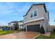 Two-story home with stone accents, a brick driveway, and well-maintained landscaping at 3310 Stonewyck St, Orlando, FL 32824