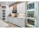Well-equipped modern kitchen with designer cabinetry, a wine fridge and a center island at 3310 Stonewyck St, Orlando, FL 32824